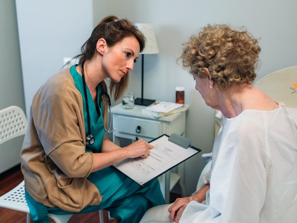 Older person discussing their health with their doctor