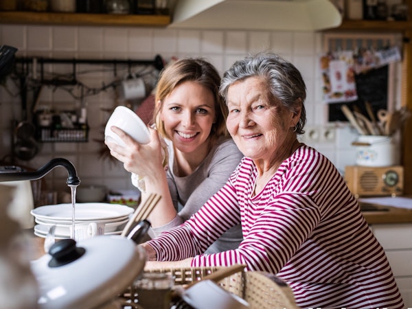 Older woman receiving assistance at home