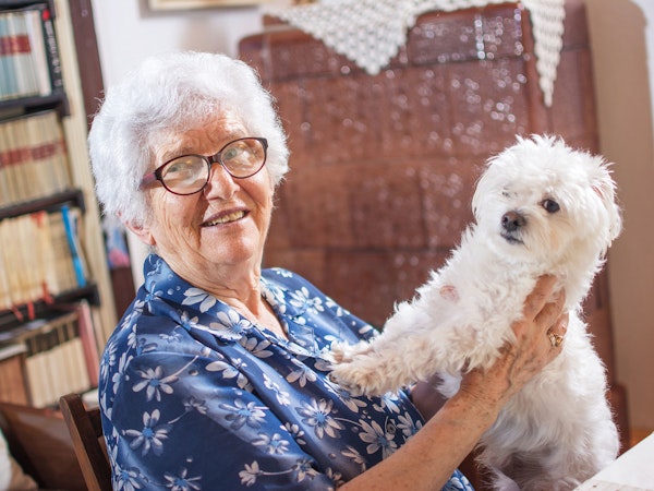 Older woman enjoying her independence at home with her dog