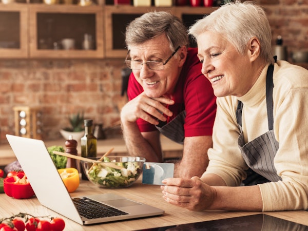 Older couple making an online recipe
