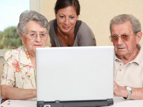 Older couple and daughter looking at Carer Gateway.