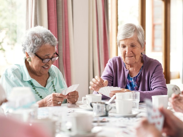Older residents at a table for tea