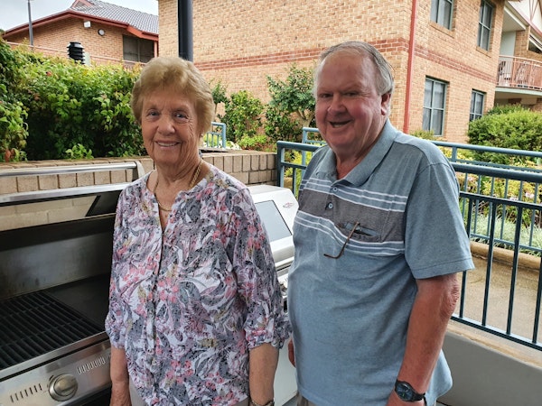 Two older retirees at their retirement village barbecue spot.